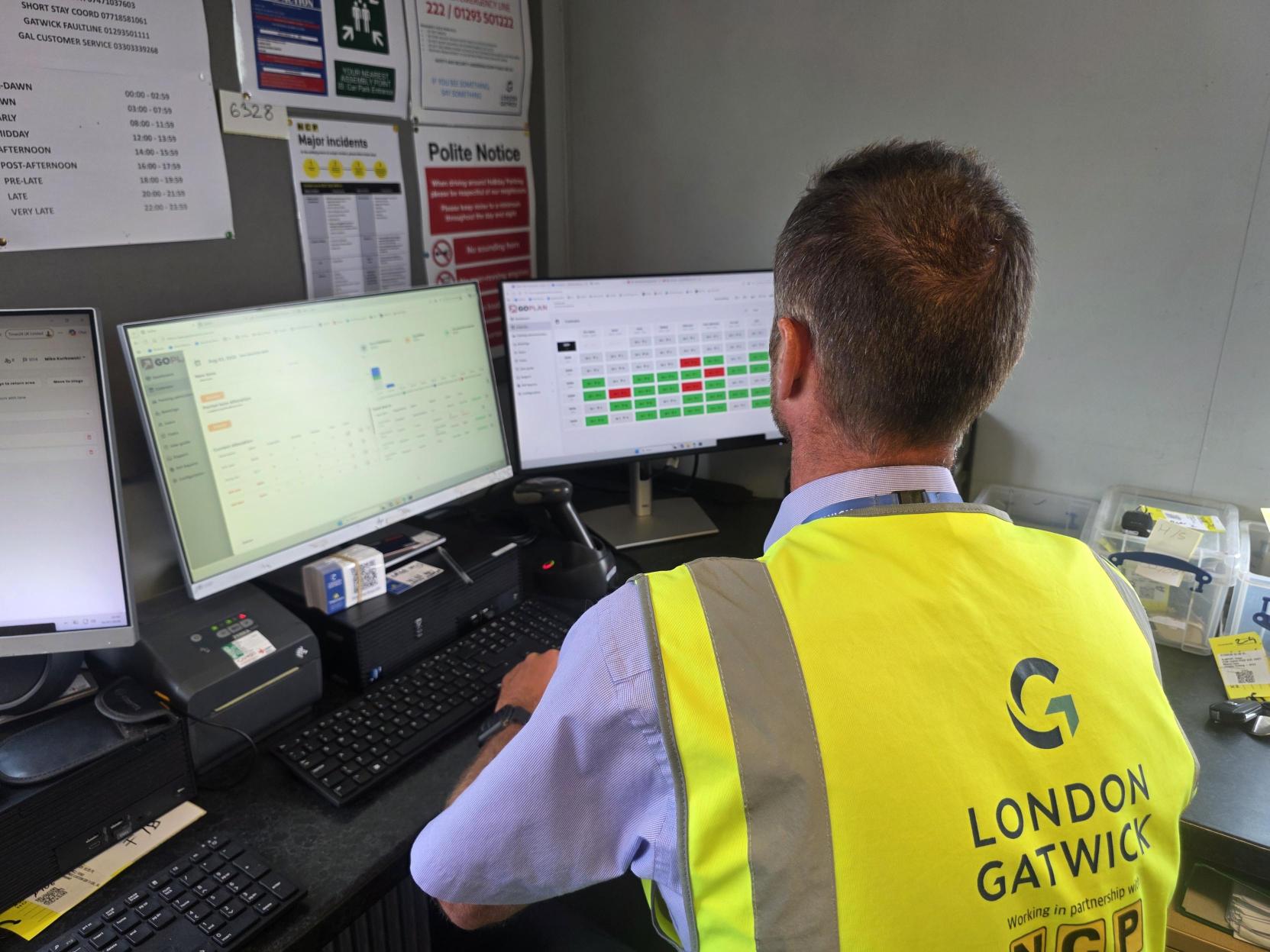 An Assured Technologies controller at London Gatwick monitoring parking operations across a bank of screens